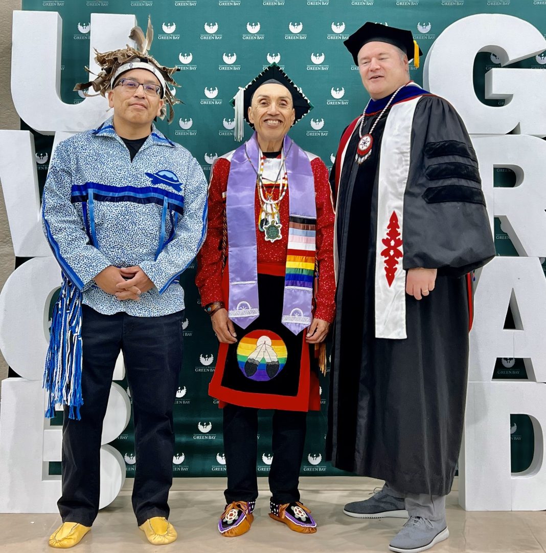 Joseph Rey Torres (center) at his UW-Green Bay graduation ceremony in May 2023. He's surrounded by UWGB professor Forrest Brooks (l) and professor J P Leary (r). (Courtesy of Joseph Rey Torres)