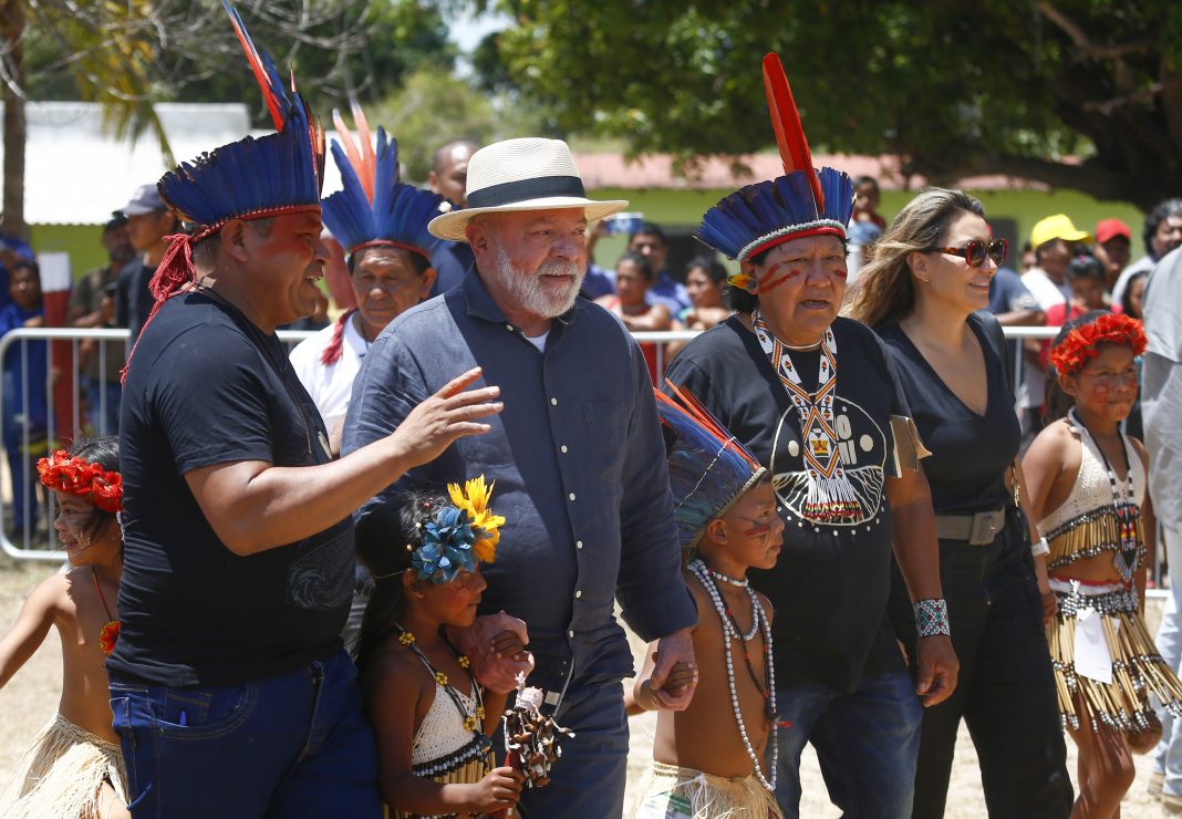 FILE - Brazil's President Luiz Inacio Lula da Silva, second left, and first lady Rosangela Silva, second from right, are received by an Indigenous party including Davi Kopenawa, a Yanomami leader and shaman, third from right, at the Caracarana Lake Regional Center in Normandia, on the Raposa Serra do Sol Indigenous reserve in Roraima state, Brazil, March 13, 2023. Rio de Janeiro's Salgueiro samba school paid tribute to the the Yanomami, Brazil’s largest Indigenous group, on Sunday, Feb. 11, 2024 in the Carnival parade at the Sambadrome. (AP Photo/Edmar Barros, File)