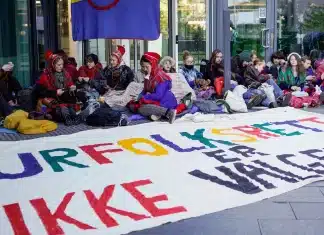 Norway agrees to compensate Indigenous people over land for Europe’s largest onshore wind farm Activists wearing traditional Sami outfits sit in protest outside the entrance of Statkraft, a state-owned company that operates 80 of the wind turbines at Fosen. - Copyright Cornelius Poppe/NTB Scanpix via AP, File