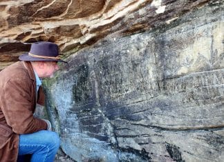 Scientists say carvings in southern W.Va. are Native American, not Irish David Sibray examines the Lynco Petroglyph, also known as the Luther Elkins Petroglyph, near Oceana, West Virginia.