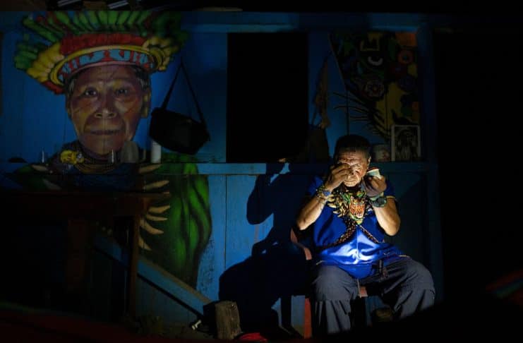Isidro Lucitante, a healer of the indigenous Cofan ethnic group, gets ready for an ayahuasca ceremony in Avie village, in Lago Agrio, Sucumbíos Province, Amazon region, Ecuador. Image: PEDRO PARDO/AFP via Getty Images