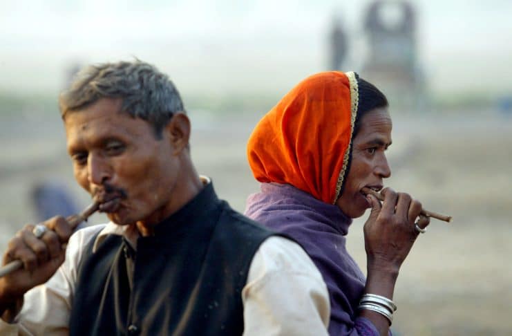 A nomadic couple brushes their teeth using neem (native Indian tree) sticks in Allahabad, India. Members of this nomadic tribe move from one city to another camping on street sides and making a living by picking up odd jobs. As income starts to dip, they move en masse to another city and start over again. AP Photo/Rajesh Kumar Singh