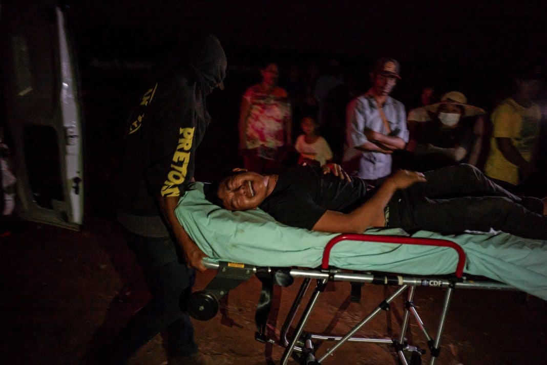 An injured indigenous person is transported as Guarani-Kaiowa Indigenous people, who are reclaiming land, conflict with men backed by farmers in trucks and tractors in Douradina district, state of Mato Grosso do Sul, Brazil August 3, 2024. REUTERS/Gabriel Schlickmann