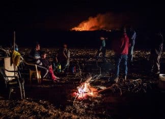 Farmers attack Indigenous people reclaiming land in Brazil Guarani-Kaiowa Indigenous people, who are reclaiming land, stand in a camp during a conflict with men backed by farmers in trucks and tractors in Douradina district, state of Mato Grosso do Sul, Brazil August 3, 2024. REUTERS/Gabriel Schlickmann