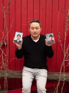 Tom Pyun, 46, a Korean American writer, poses for a portrait holding photos of his parents.Arin Yoon