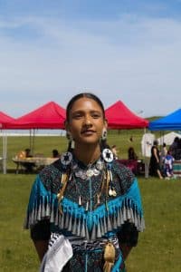 Mary-Ann Manatch, a woodland traditional dancer, at the 2024 Na-Me-Res powwow in Toronto. Manatch said the burgundy colour and the strawberry beadwork remind them of eating strawberries after a sweat lodge ceremony.