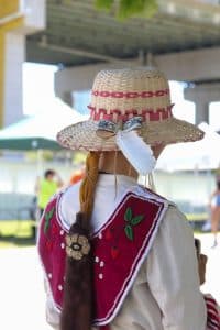 Mary-Ann Manatch, a woodland traditional dancer, at the 2024 Na-Me-Res powwow in Toronto. Manatch said the burgundy colour and the strawberry beadwork remind them of eating strawberries after a sweat lodge ceremony.