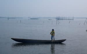 A man inspects his net as he fishes at Laguna de Bay in Manila, Philippines. The lagoon has been earmarked for a trial of floating photovoltaic panels that could produce 2 gigawatts of electricity. REUTERS/Erik De Castro Purchase Licensing Rights