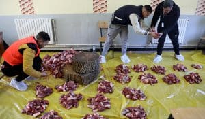 Men prepare portions of meat as part of Algeria's Tamechrit, based on the Amazigh New Year's traditions, in Bajaia, on January 11, 2025. (AFP)