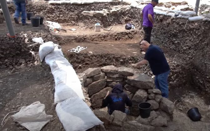 Archaeologists excavating the shaman's tomb. Credit: Israel Antiquities Authority