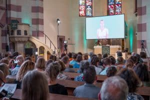 The congregation at St. Paul’s Church in Bavaria, Germany, watches an AI service. Photo: DPA/Picture Alliance via Getty Images