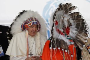 Pope Francis receives a headdress during his visit to Maskwacis, Alberta. (Reuters: Todd Korol )