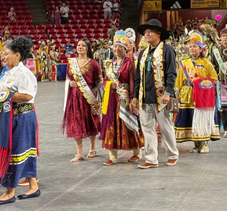 Arizona State University Powwow royalty lead a grand entry march into the event at Desert Financial Arena in Tempe on April 6, 2025.