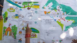 Kamala Kadria, a woman from the Gadaba Indigenous community, points to a spot on a map they made in Hatipakna village, Koraput district, in India's eastern state of Odisha.AP Photo/Rafiq Maqbool