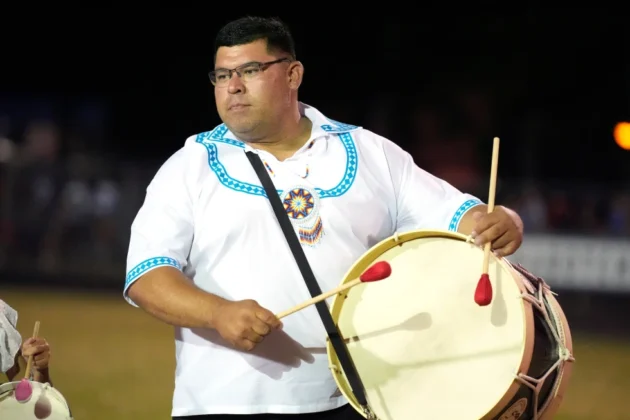 Mississippi Band of Choctaw Indians Tribal Chief Cyrus Ben plays the drumming cadence prior to a World Series of Stickball title game, July 13, 2024, in Choctaw, Miss. (AP Photo/Rogelio V. Solis, File)