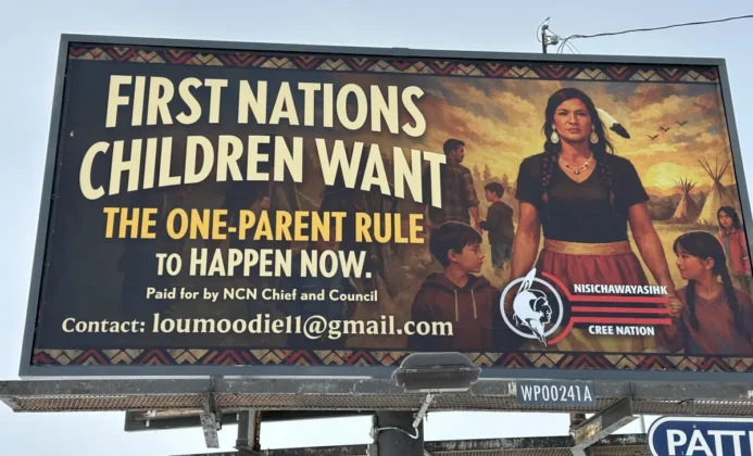 At least 15 billboards, including this one, have been placed across the Canadian province of Manitoba by Lou Moodie, Nisichawayasihk Cree Nation, in support of changes to the Indian Act to eliminate a so-called “second-generation cut-off,” which limits the ability to pass on Indian Status to future generations.